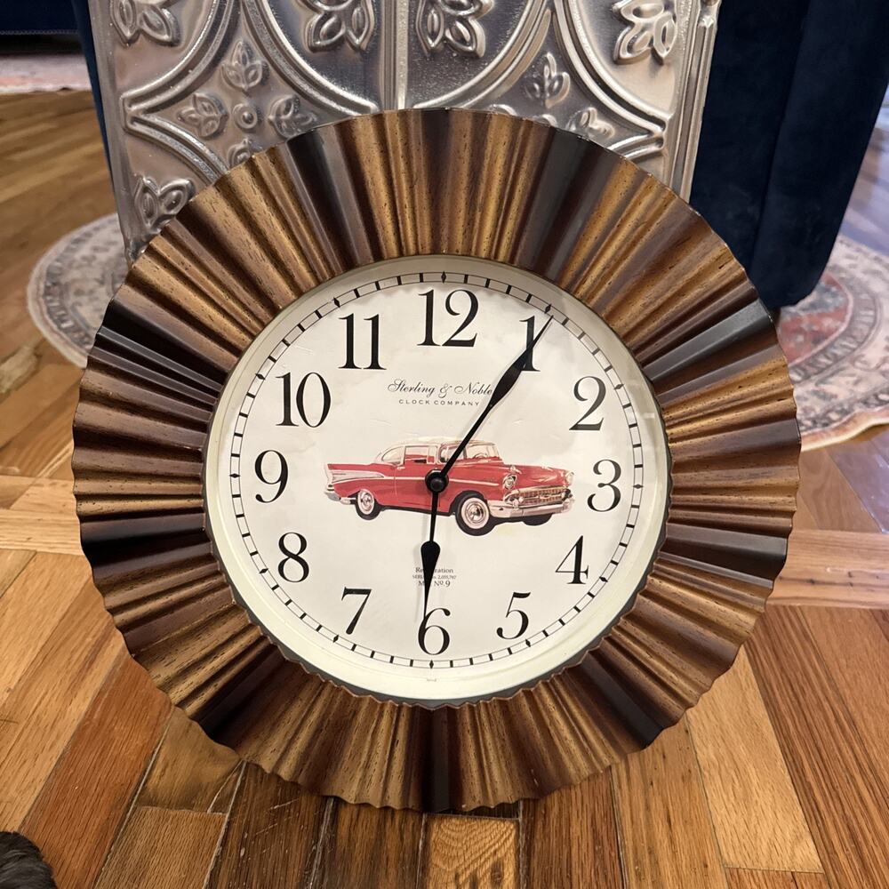 Sterling & NobleVNTGwall clock with a brown and gold ripple wood frame and a red